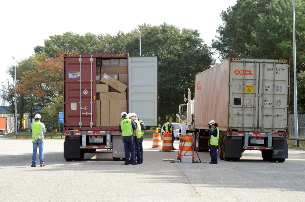 Inspectors beside two container trucks at Norfolk International Terminal during a 2010 multi-agency truck and cargo inspection