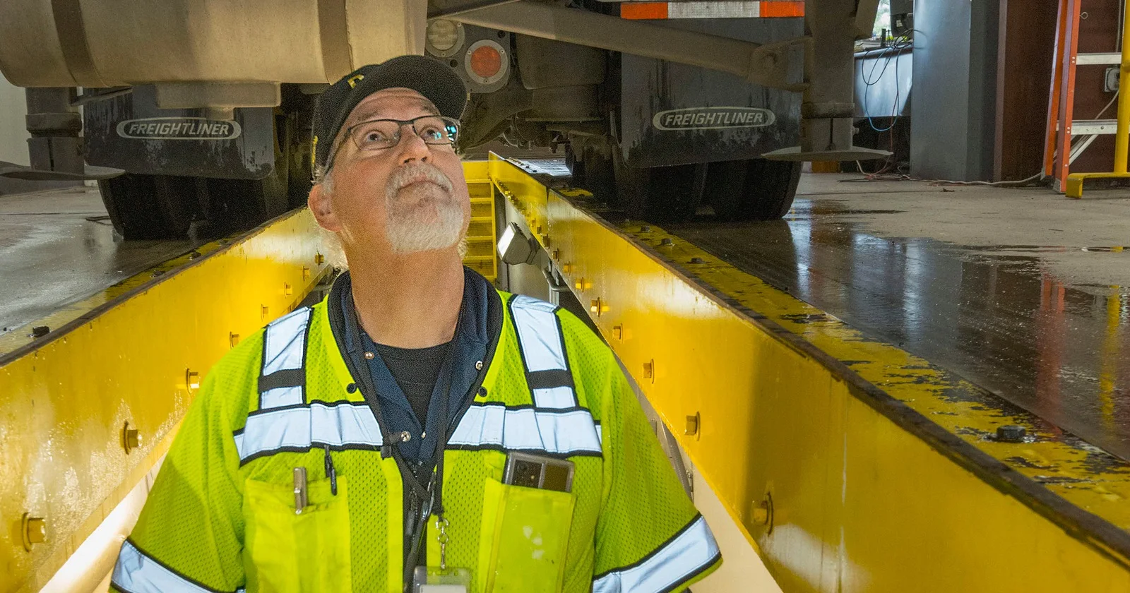 An Oregon DOT inspector examines a truck from an inspection pit at Woodburn Port of Entry in January 2023